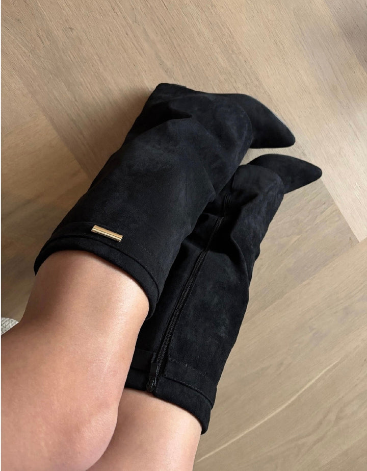 Women's black tall wedge boots with pointed toes, side zips and metal trim