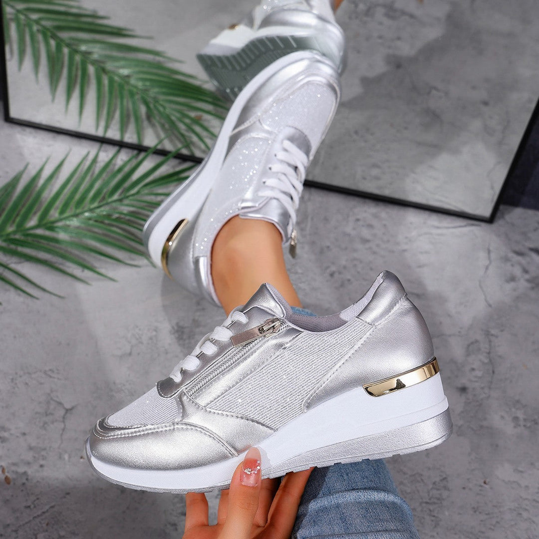 Women's silver metallic platform sneaker with lace-up front, side zip, and chunky white sole