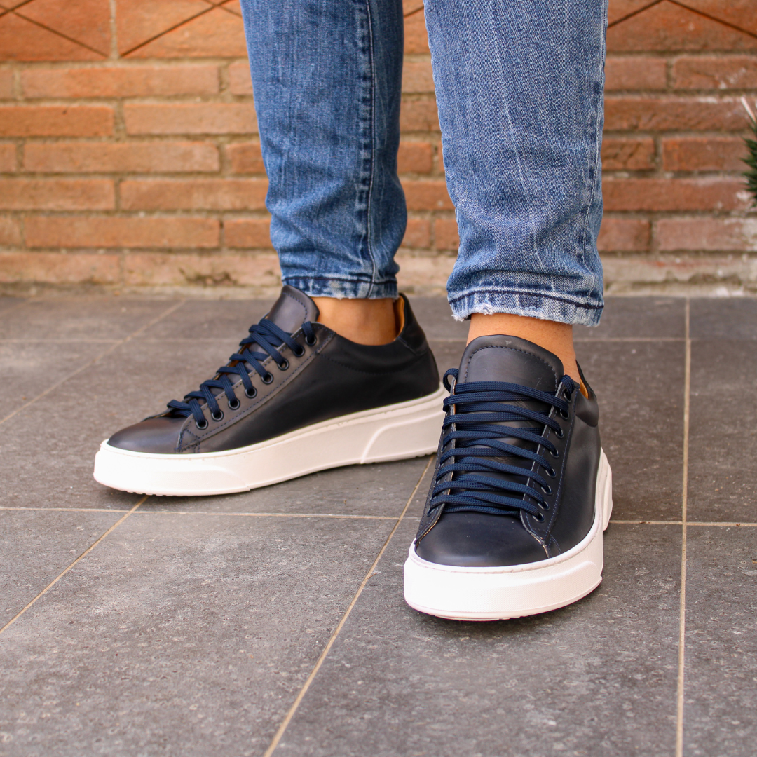 Black low-top lace-up sneaker with white platform sole