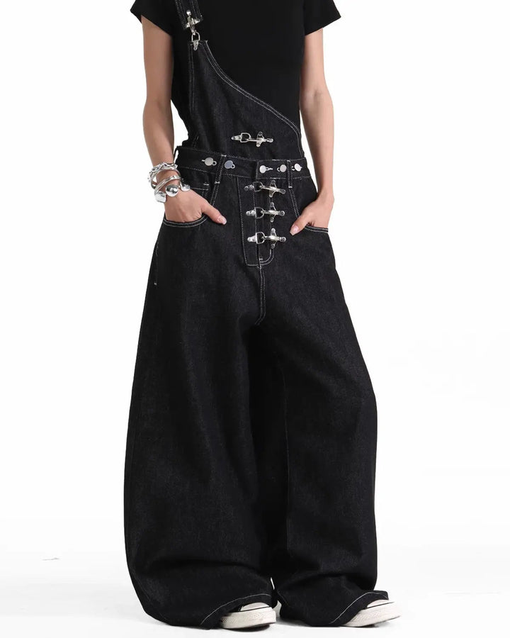 Black asymmetric denim overalls with buckle details and wide legs