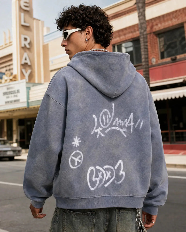 Washed zip-up hoodie with graffiti-style lettering and front pockets