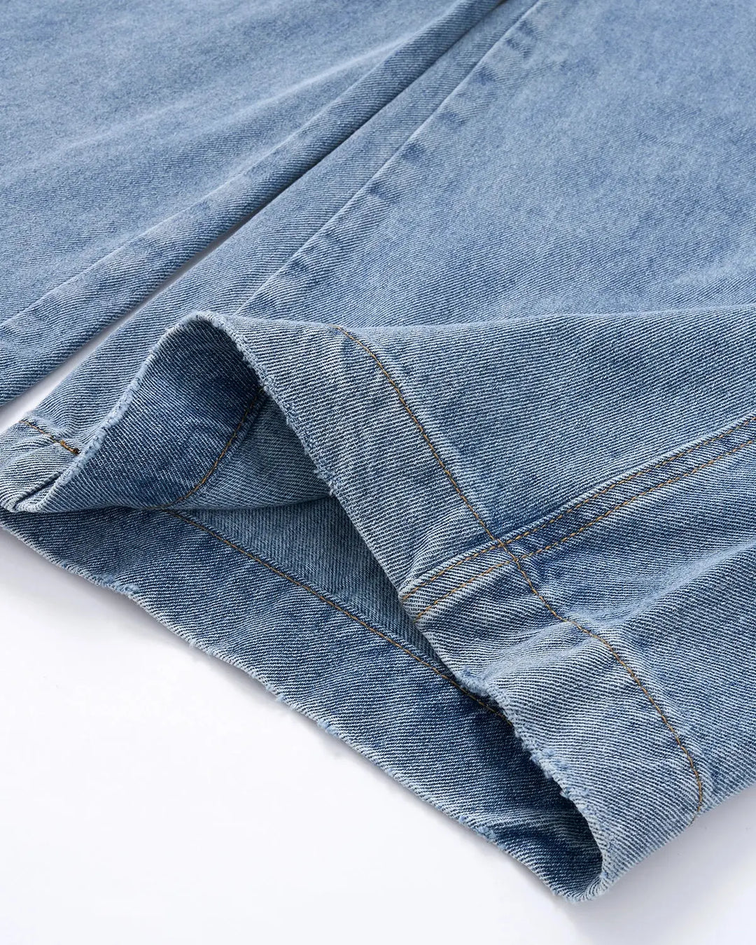 Light blue barrel jeans with dark script graphic on one leg