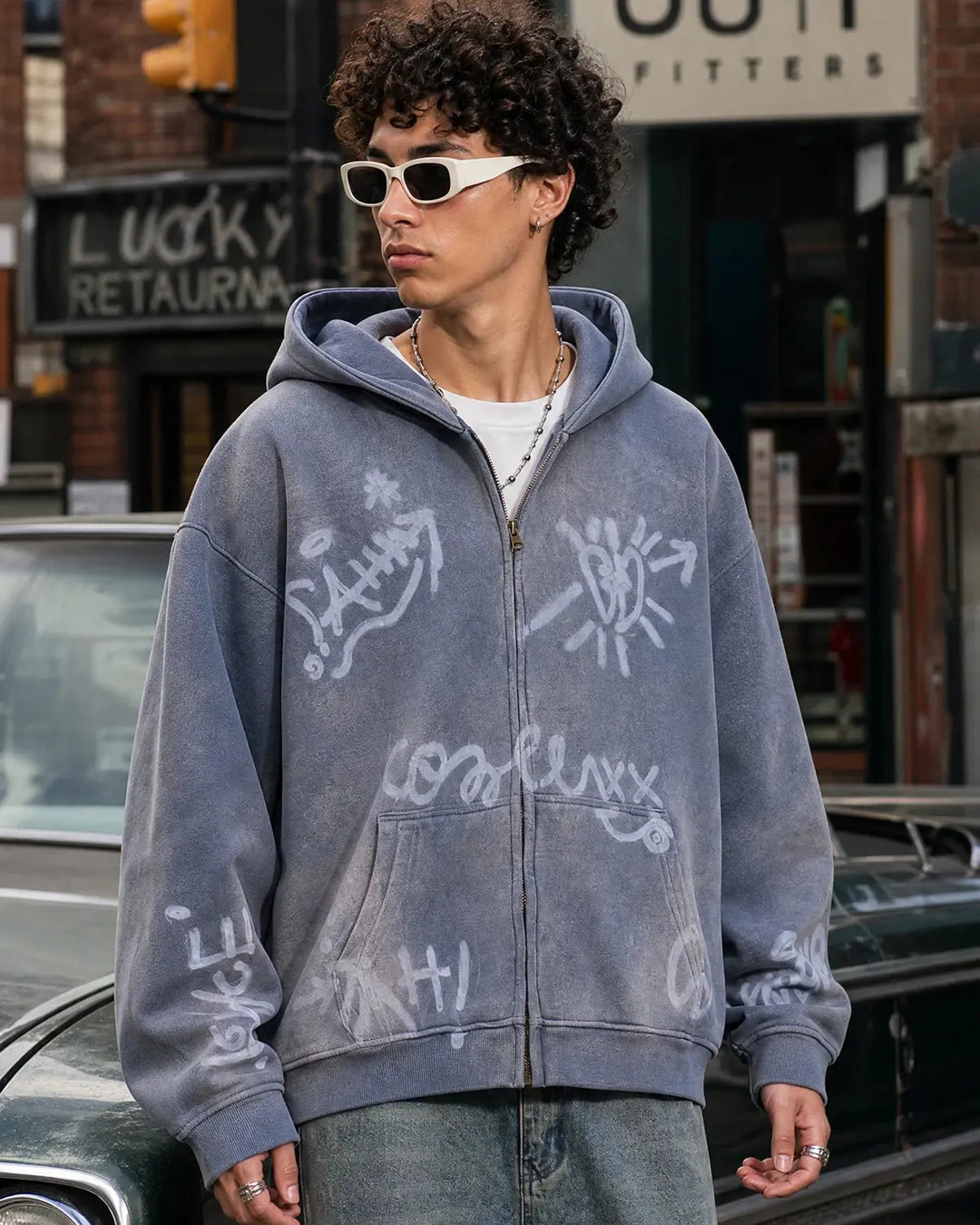 Washed zip-up hoodie with graffiti-style lettering and front pockets