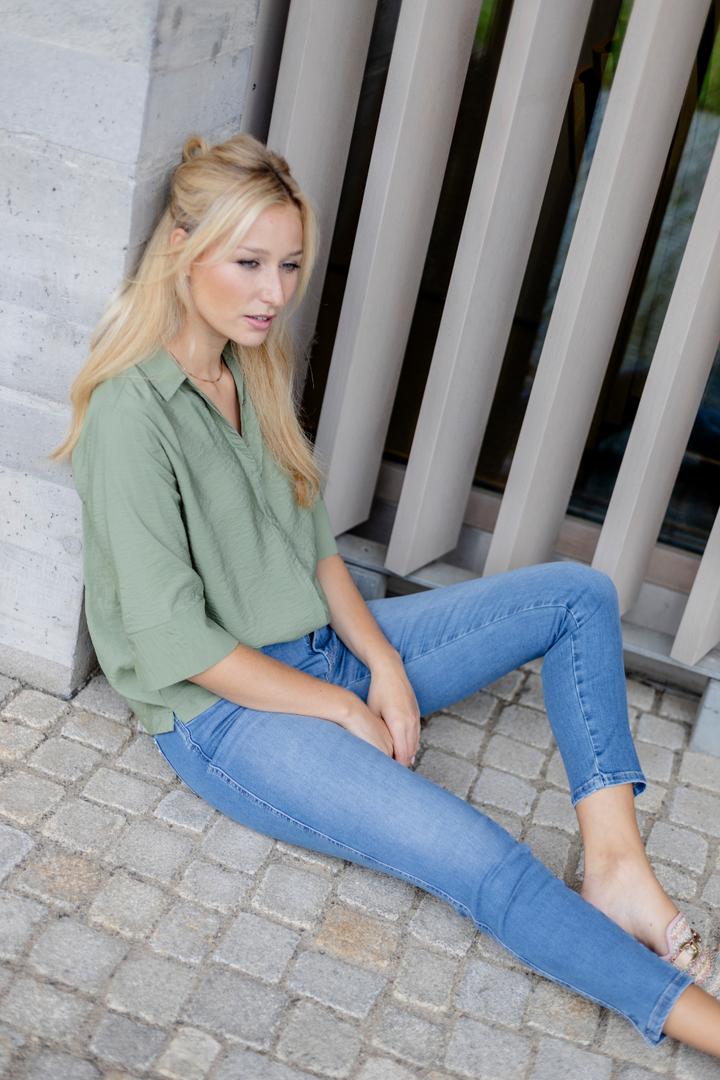 Women's light blue slim fit jeans with low-rise waist and star pocket detail