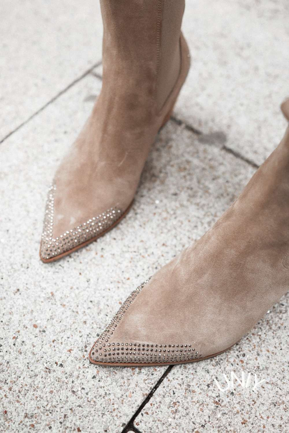 Women's beige pointed-toe western ankle boots with studded toes