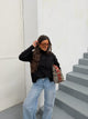 Women's black high-neck jumper with scattered dark embellishments and long sleeves