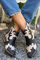 Black and cream patterned cutout ankle boots with pointed toes and low block heels