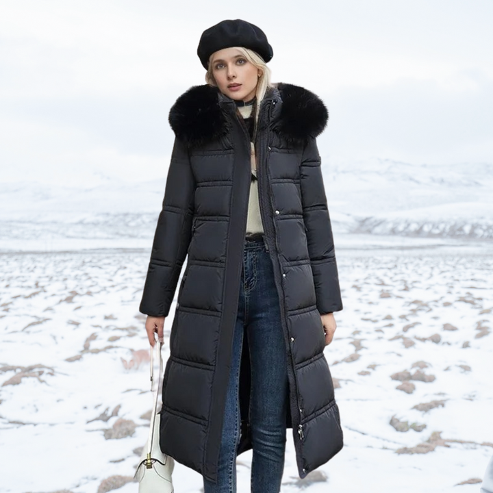 Women's longline quilted coat with fur-effect collar in a snowy outdoor setting