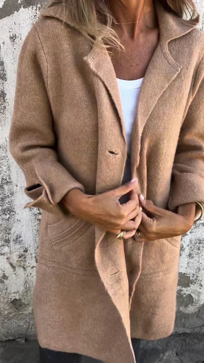 Women's long button-front coat with notched lapels and patch pockets