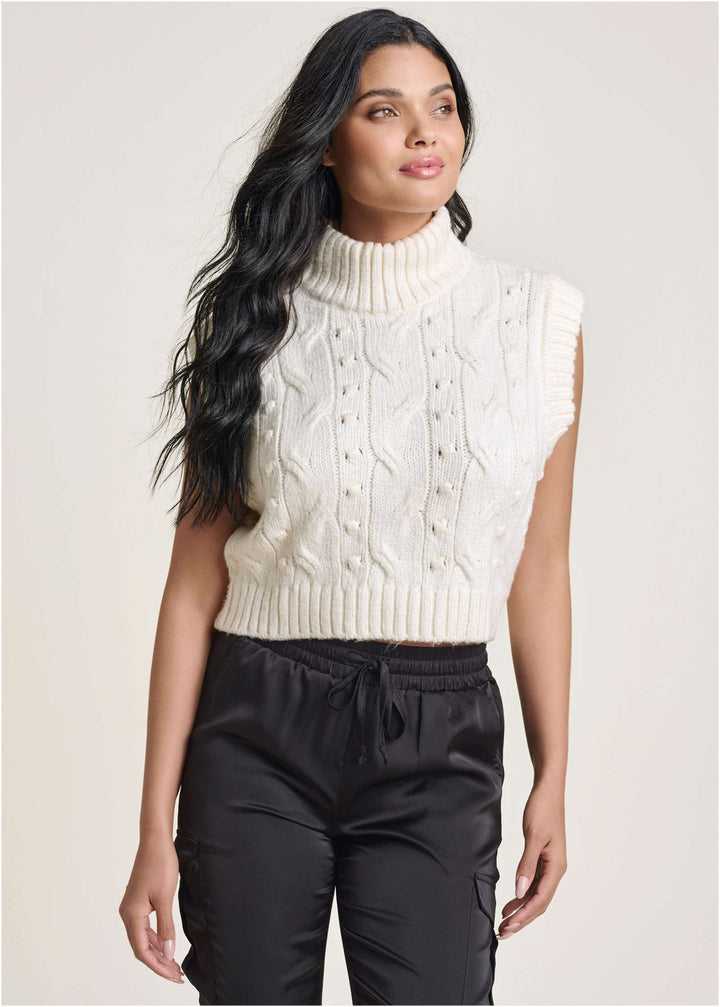Women's cream cable knit sleeveless sweater vest with turtle neck