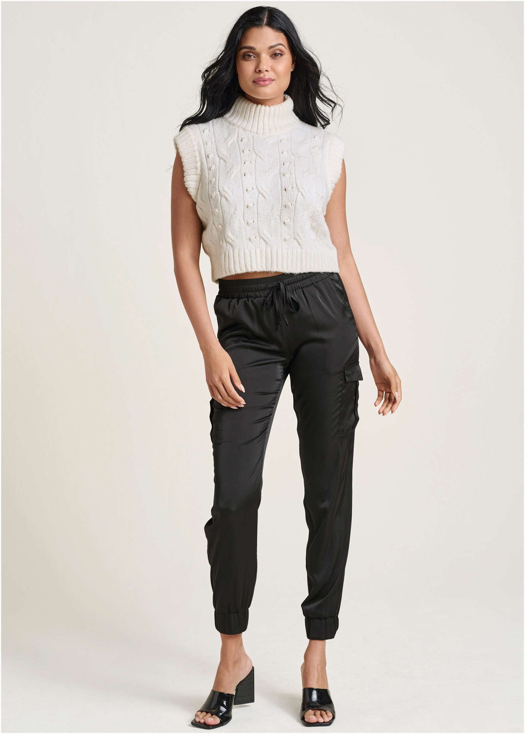 Women's cream cable knit sleeveless sweater vest with turtle neck