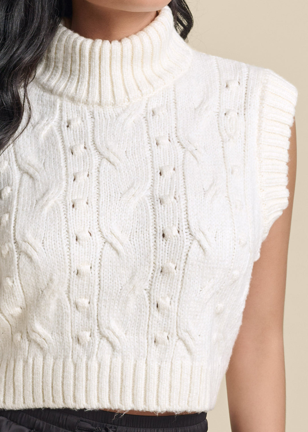 Women's cream cable knit sleeveless sweater vest with turtle neck