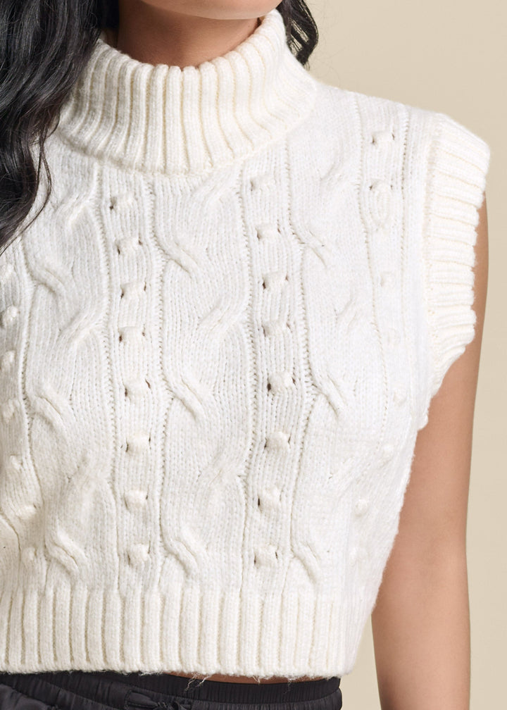 Women's cream cable knit sleeveless sweater vest with turtle neck