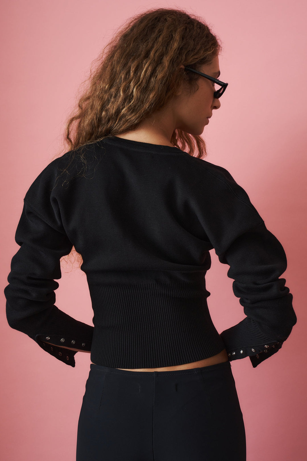 Women's black cropped knit cardigan with crew neckline, long sleeves and front buttons