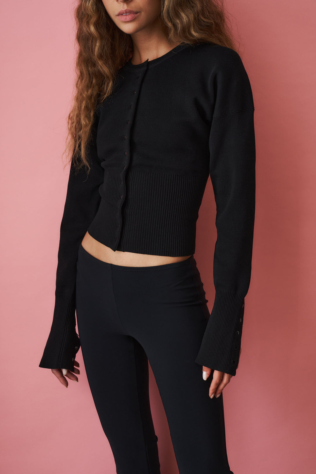 Women's black cropped knit cardigan with crew neckline, long sleeves and front buttons