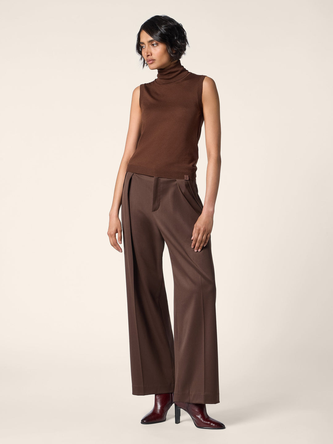 Women's brown sleeveless mock neck sweater with slim fit