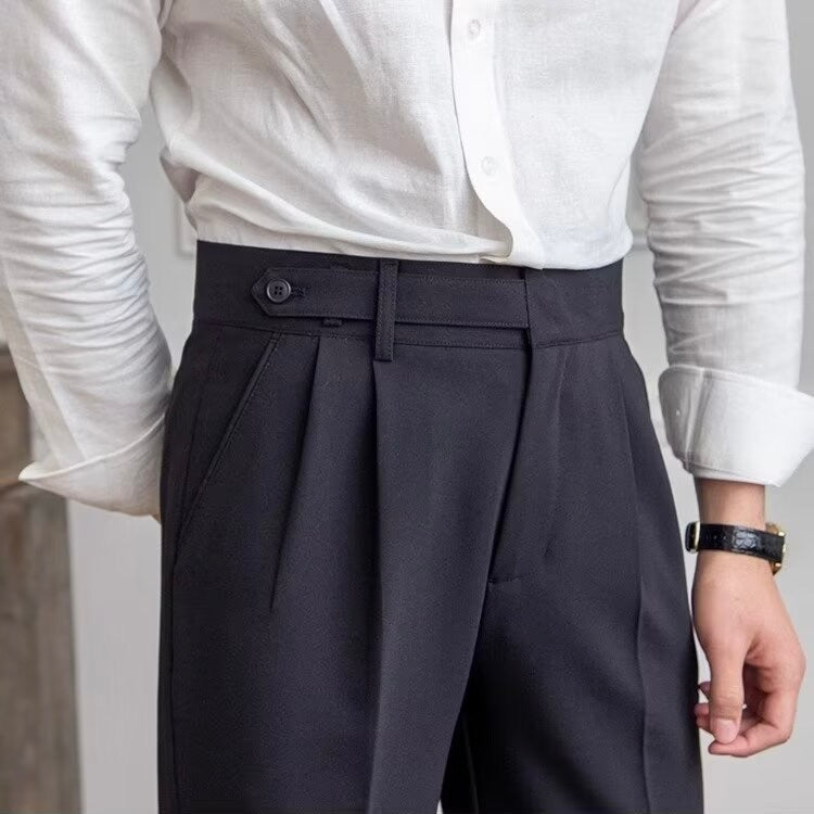 Woman wearing high-rise pleated tailored trousers in beige, cropped ankle length