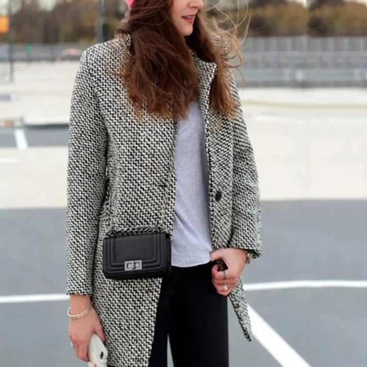 Women's black and white houndstooth long coat with notched lapels and button fastening