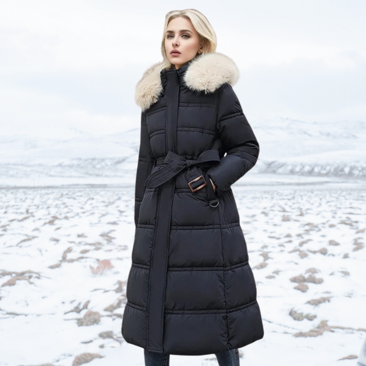Women's longline quilted coat with fur-effect collar in a snowy outdoor setting
