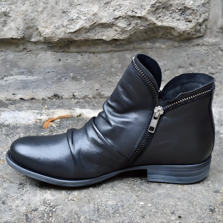Purple ankle boot with ruched upper, side zipper and low heel