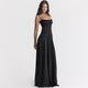 Women's black maxi dress with cowl neckline and cami straps, showing full-length floor skirt and back tie detail