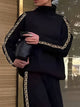 Women's black high neck sweatshirt with geometric sleeve trim