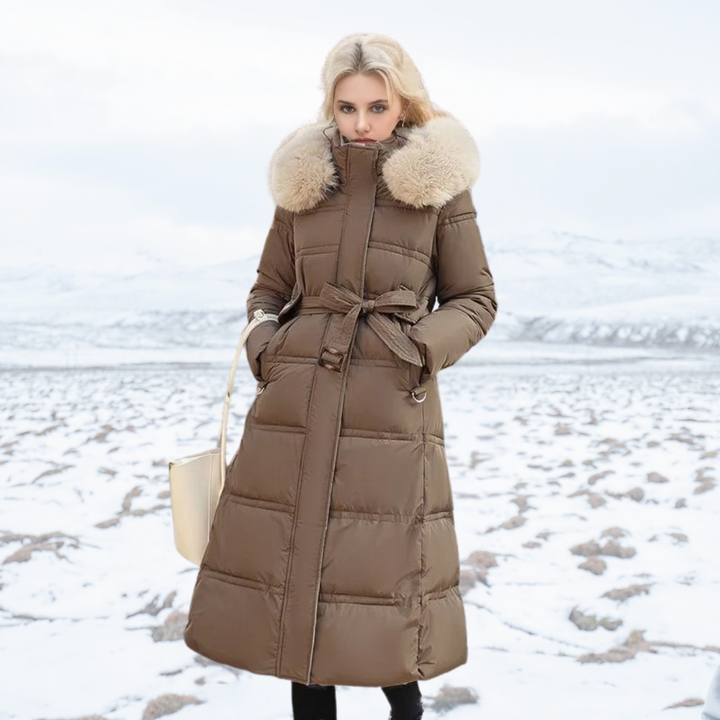 Women's longline quilted coat with fur-effect collar in a snowy outdoor setting