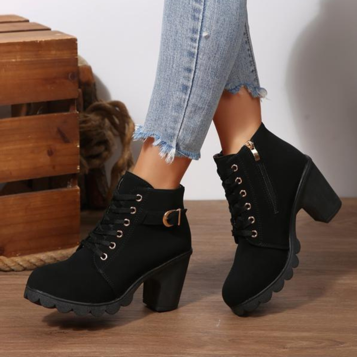 Women's black lace-up ankle boots with metal buckle strap and chunky block heel on platform sole