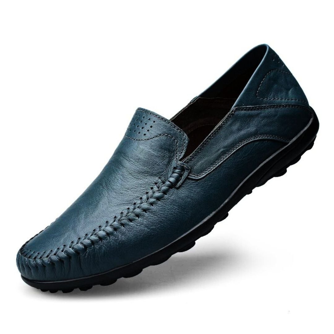 Men's slip-on loafers with stitched front detail and flat textured soles