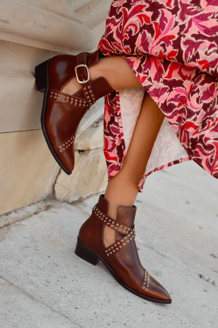 Women's brown pointed ankle boots with studded buckle straps