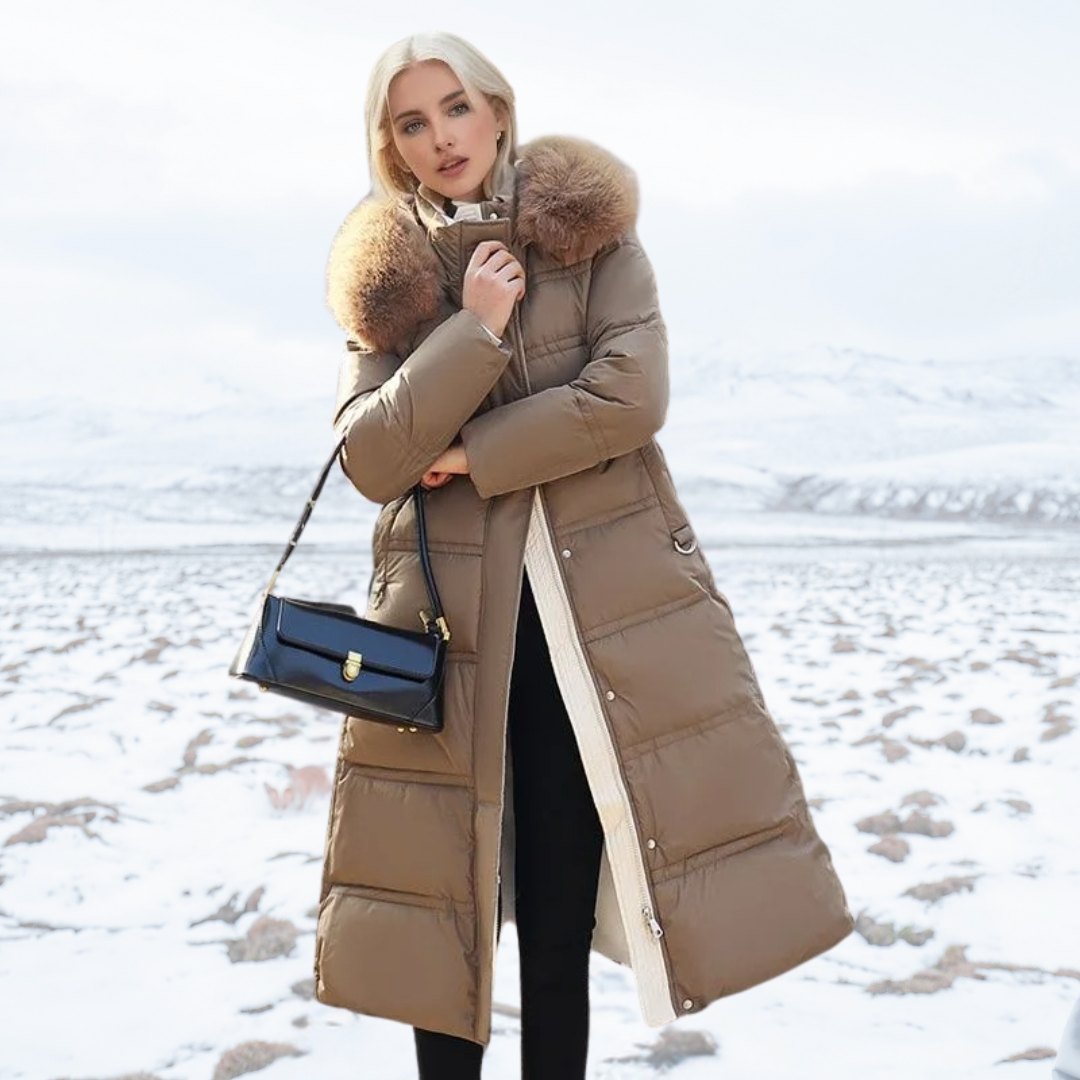 Women's longline quilted coat with fur-effect collar in a snowy outdoor setting