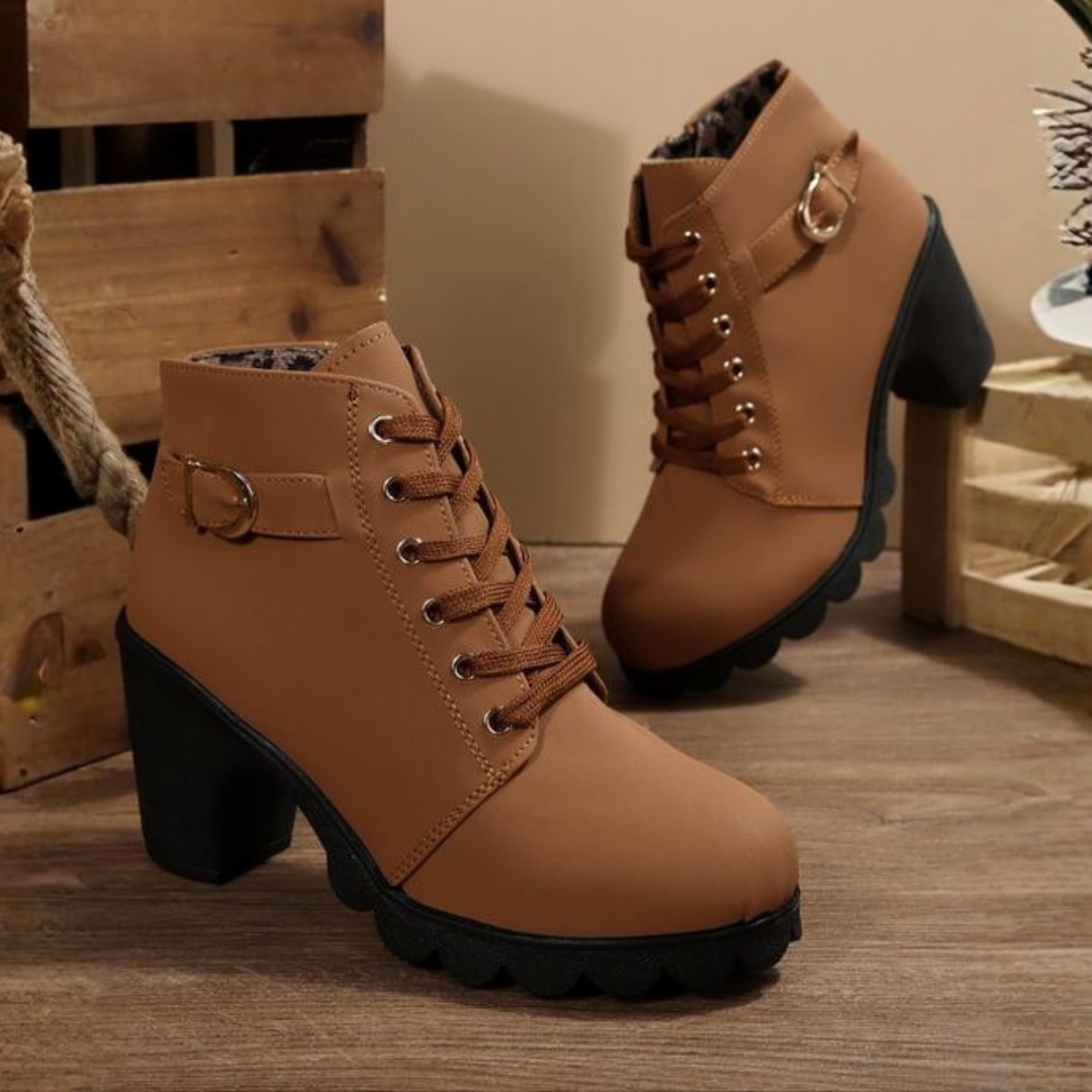 Women's black lace-up ankle boots with metal buckle strap and chunky block heel on platform sole