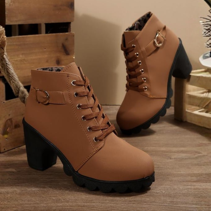 Women's black lace-up ankle boots with metal buckle strap and chunky block heel on platform sole