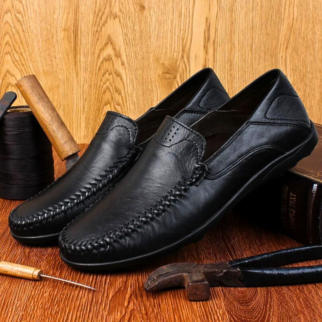 Men's slip-on loafers with stitched front detail and flat textured soles