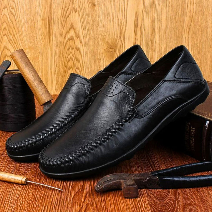Men's slip-on loafers with stitched front detail and flat textured soles