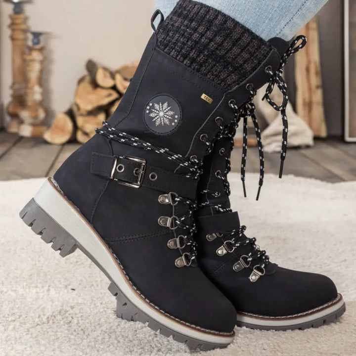 Women's lace-up snow boots with buckle straps and treaded soles