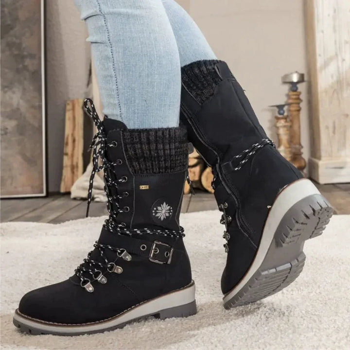 Women's lace-up snow boots with buckle straps and treaded soles