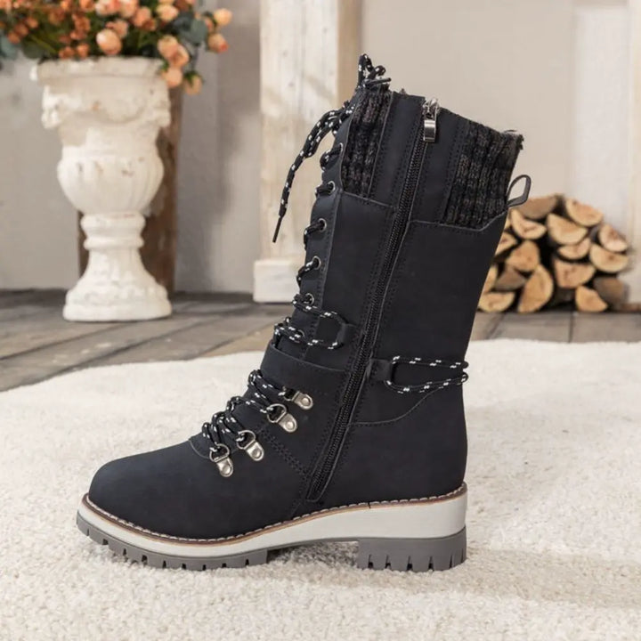 Women's lace-up snow boots with buckle straps and treaded soles