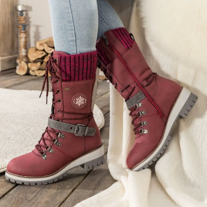 Women's lace-up snow boots with buckle straps and treaded soles