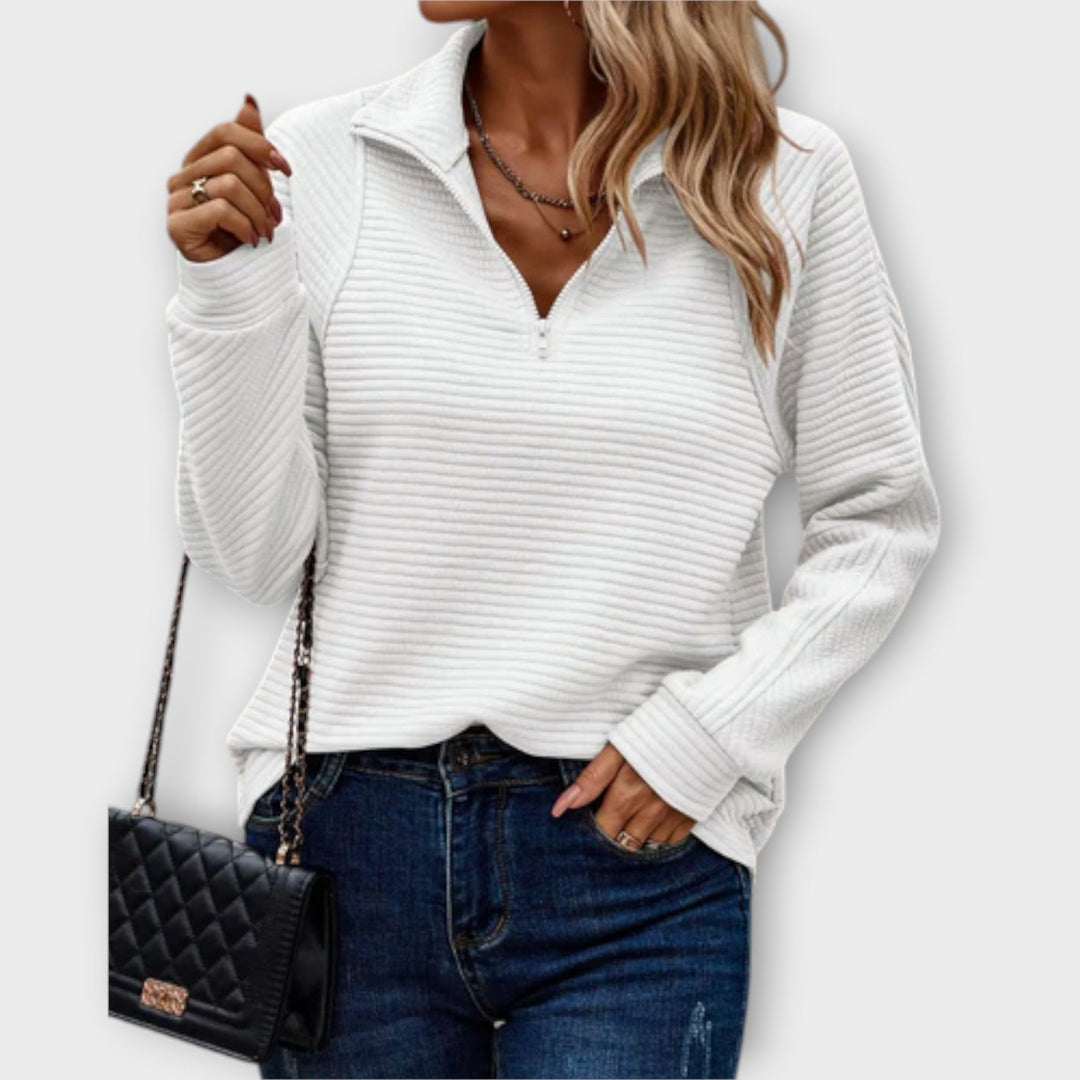 Women's ribbed knit sweater with raised collar and zip neck