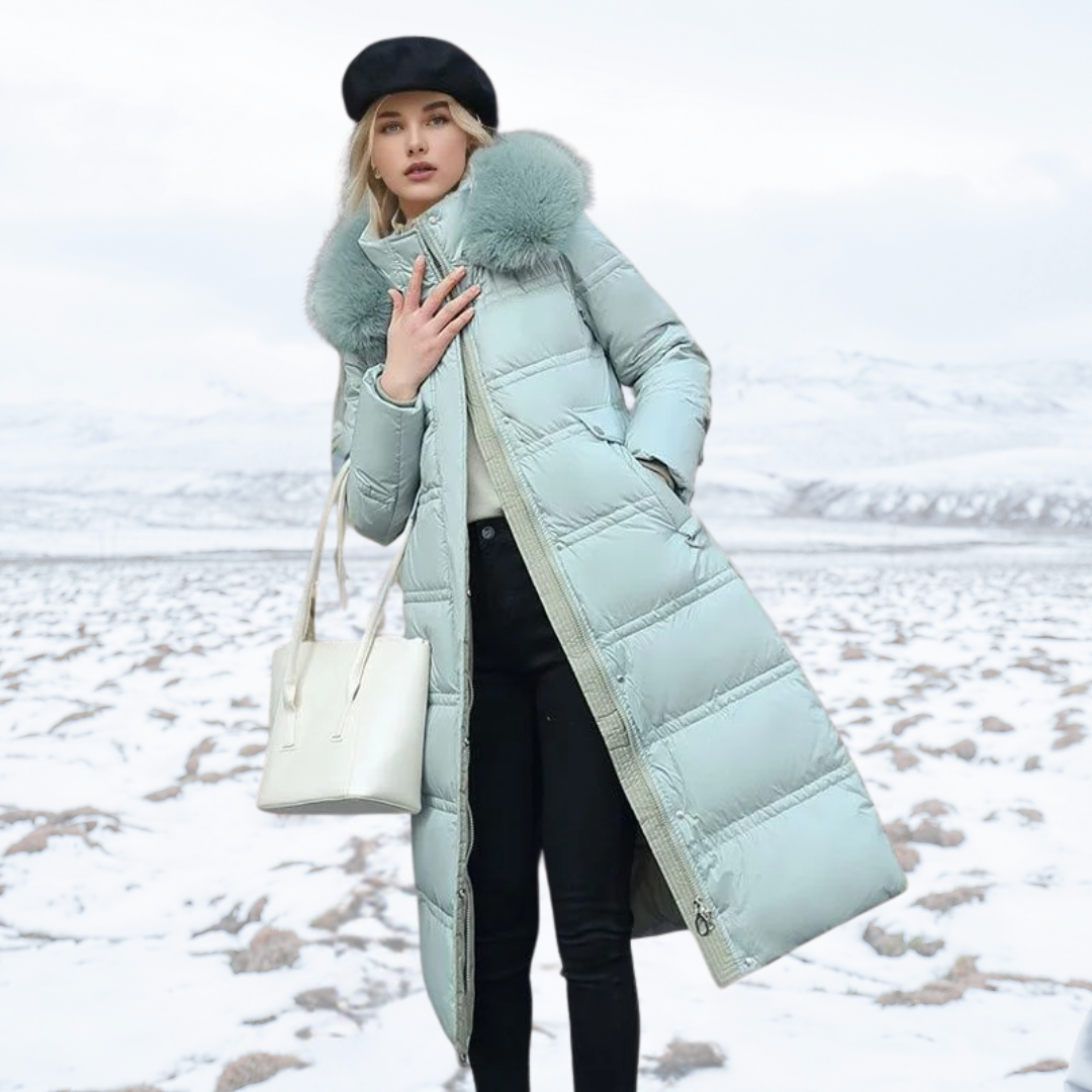 Women's longline quilted coat with fur-effect collar in a snowy outdoor setting