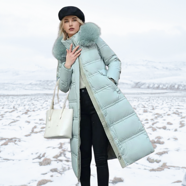 Women's longline quilted coat with fur-effect collar in a snowy outdoor setting