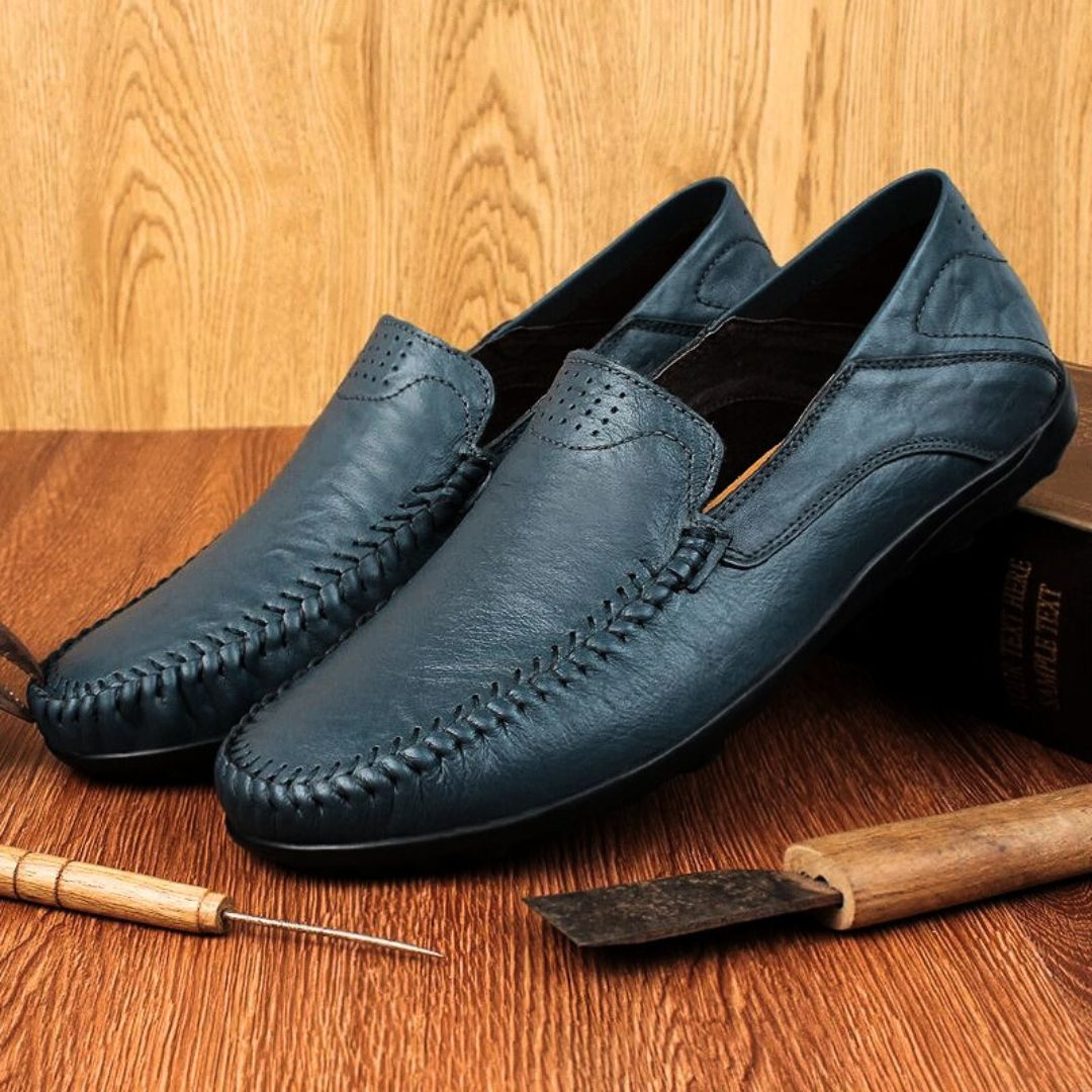 Men's slip-on loafers with stitched front detail and flat textured soles