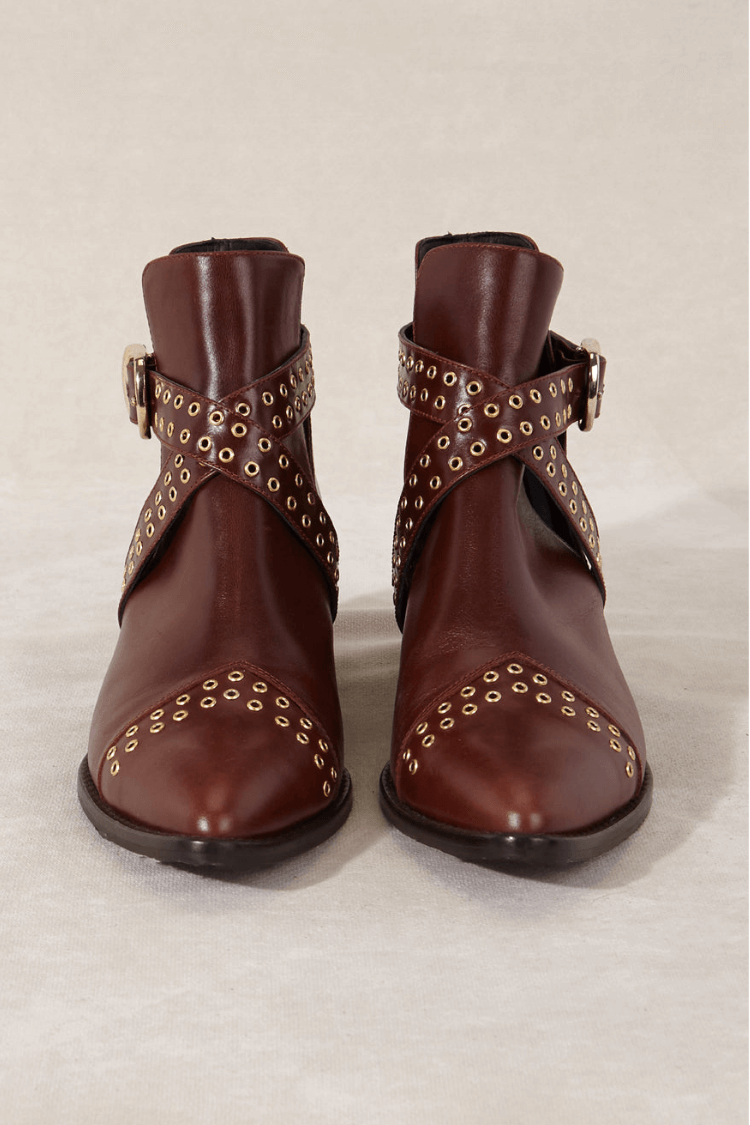 Women's brown pointed ankle boots with studded buckle straps