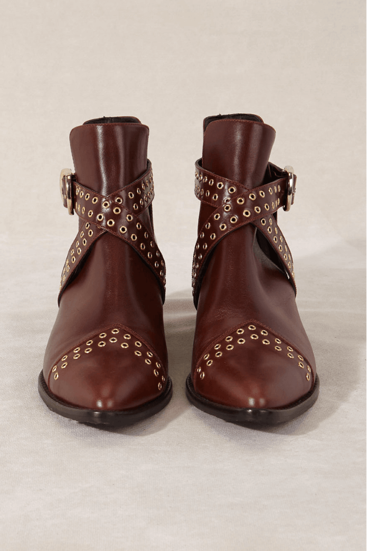 Women's brown pointed ankle boots with studded buckle straps