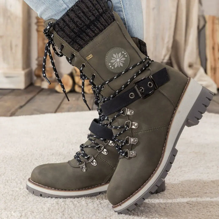 Women's lace-up snow boots with buckle straps and treaded soles