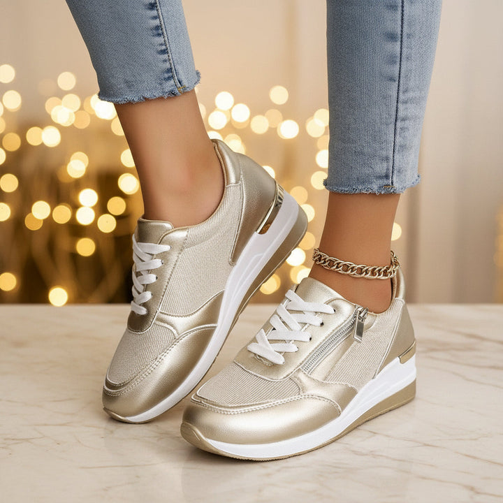 Women's silver metallic platform sneaker with lace-up front, side zip, and chunky white sole