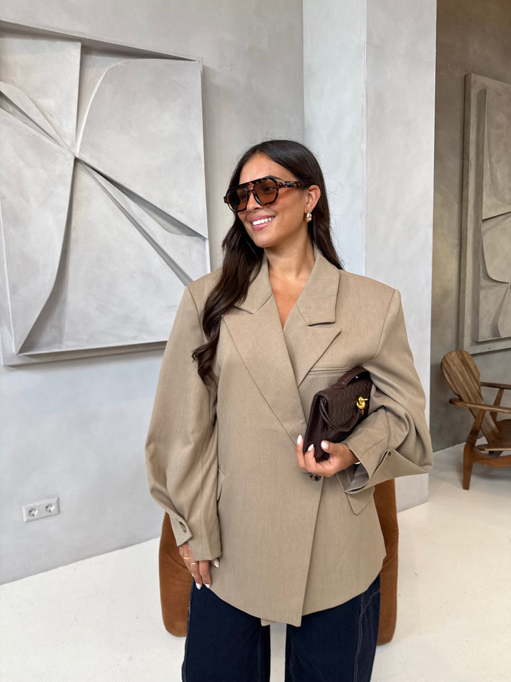 Women's beige blazer with notched lapels and button cuffs