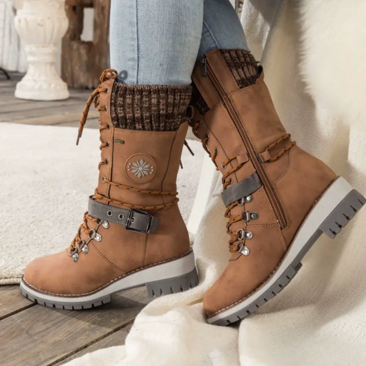 Women's lace-up snow boots with buckle straps and treaded soles