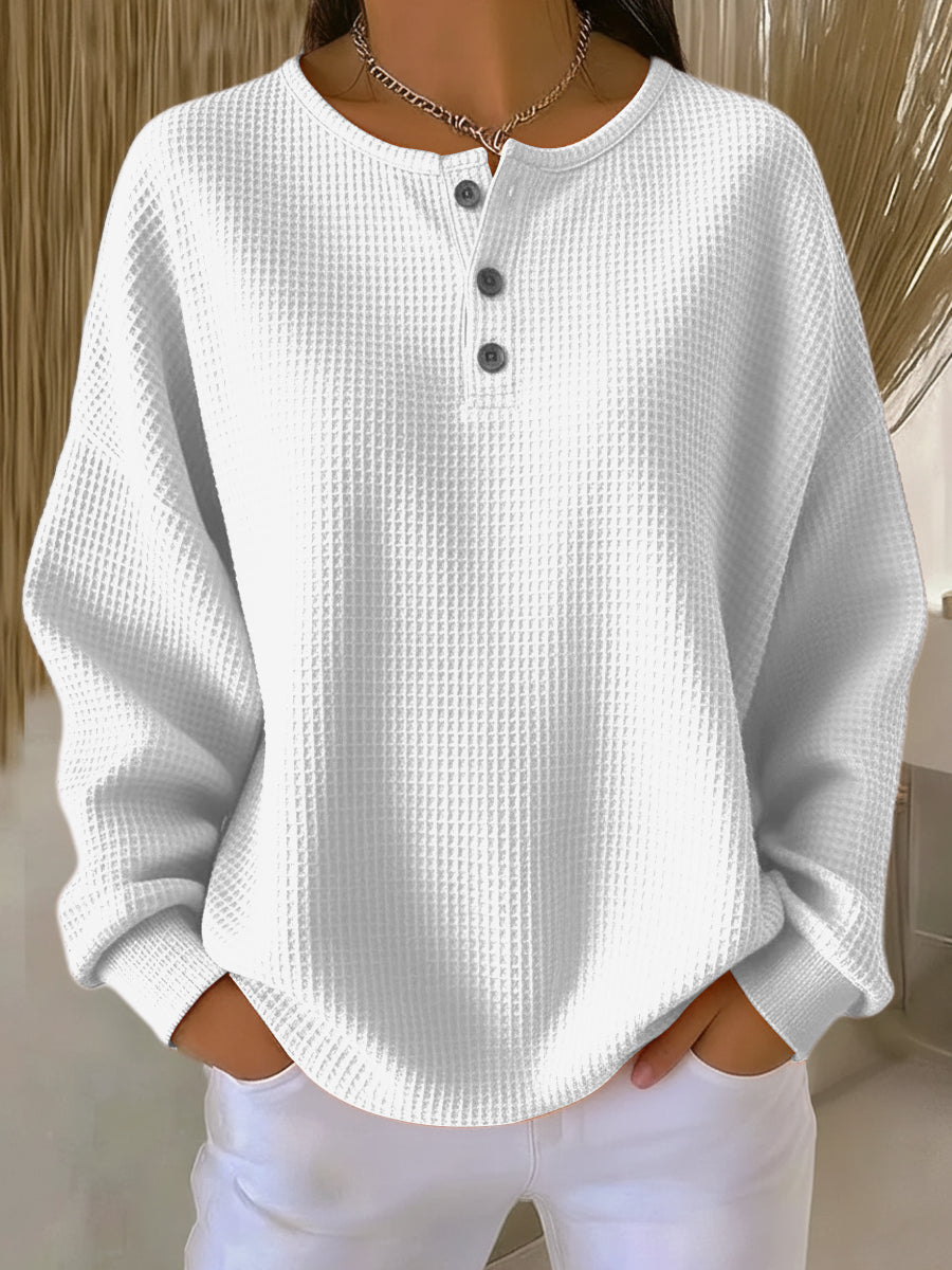 Women's long-sleeve waffle henley top with round neckline and button placket
